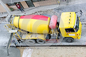 Construction worker pouring concrete from cement truck, people worker