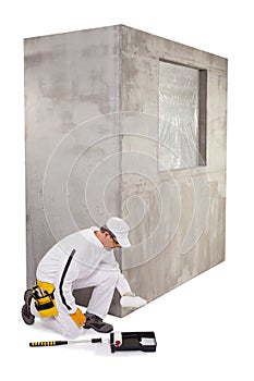 Construction worker pouring a primer in a paint tray photo