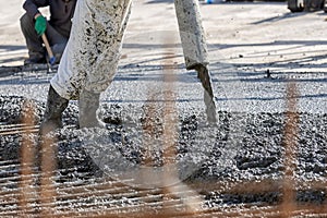 Construction worker is pouring and smoothing out concrete with ready-mix concrete (RMC).