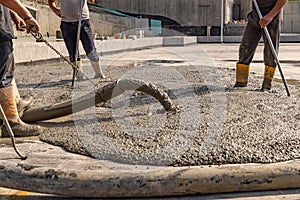 Construction worker pouring a wet concret photo