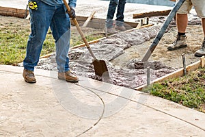 Construction Worker Pouring Wet Deck Cement Into Wooden Frame