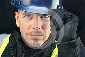 Construction Worker Putting On HardHat