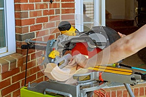 Construction worker remodeling home Carpenter cutting wooden handrails railing on with circular saw