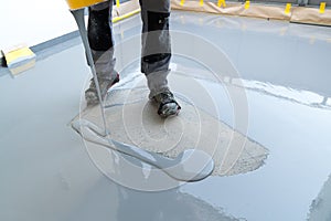 Construction worker renovates balcony floor and pours watertight resin and glue before chipping and sealing