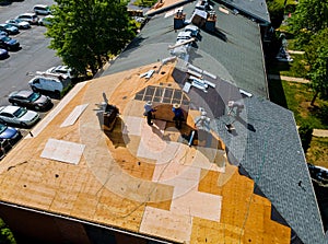 Construction worker on renovation roof the house installed new shingles