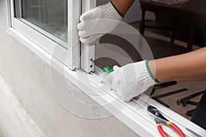 Construction worker repairing the sliding window