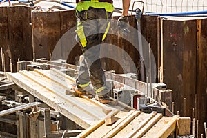 Construction worker on scaffolding on a large construction site