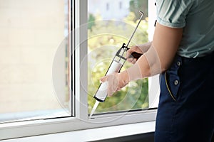 Construction worker sealing window with caul