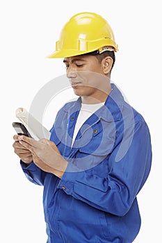 Construction worker sending a text message