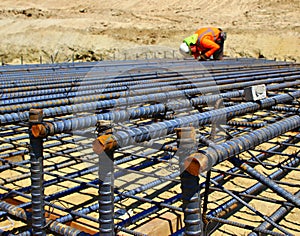 Construction worker setting rebar