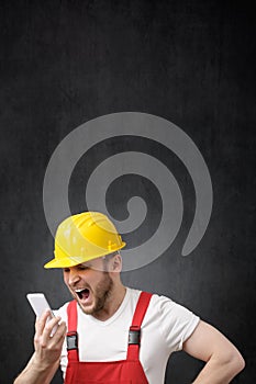 A construction worker shouting on the phone