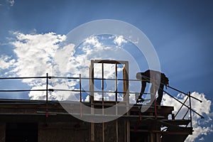 Construction Worker Silhouette on Roof