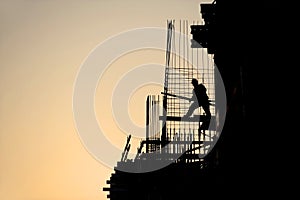 Construction worker silhouette at sunset