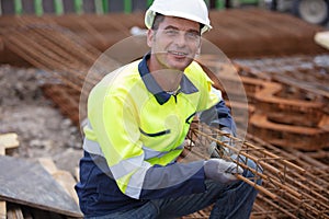 Construction worker at construction site assembling falsework photo
