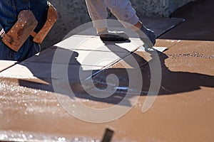 Construction Worker Smoothing Wet Cement With Hand Edger Tool