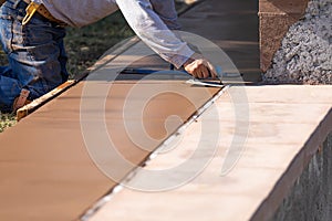 Construction Worker Smoothing Wet Cement With Hand Edger Tool photo