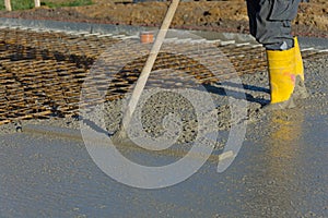 Builder smooths concrete of a floor slab