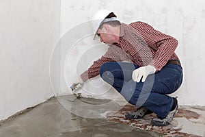 Construction worker spreading concrete