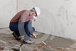 Construction worker spreading concrete