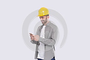 Construction Worker Standing Using Phone Isolated. Man Texting on Phone. Technology Isolated