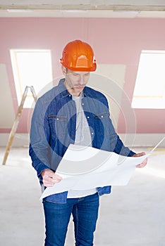 Construction worker studying blueprint