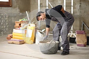 Construction worker suffering back ache and complaining