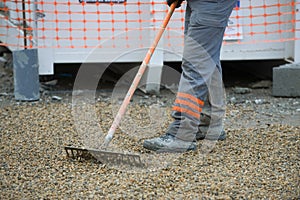 Construction worker sweeping on the building construction site