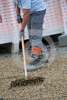 Construction worker sweeping on the building construction site