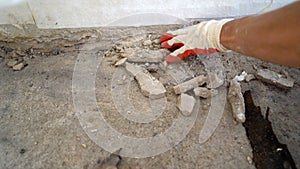 Construction worker sweeping debris with broom and dustpan