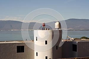 Construction worker sweeping roof top