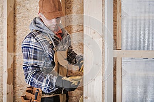 Construction Worker Taking Measurements Inside Newly Developed House photo