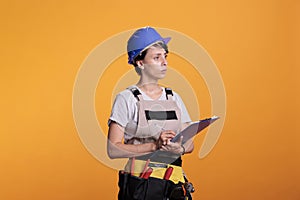 Construction worker taking notes and measurements