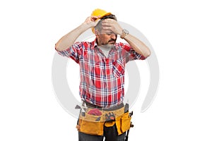 Construction worker taking off hardhat as headache gesture