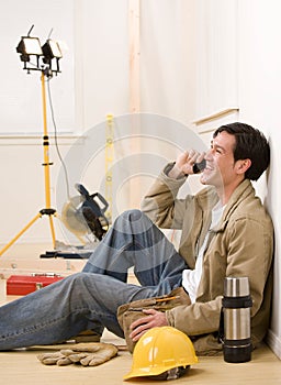 Construction worker talking on celluar phone