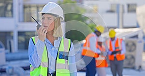 Construction worker, talking and communication on radio, walkie talkie on site for industrial project management or