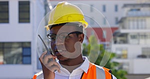 Construction worker, talking and communication on radio, walkie talkie on site for industrial project management or