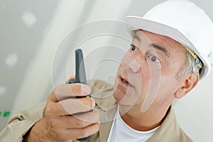 Construction worker talking with walkie talkie