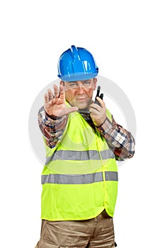 Construction worker talking with a walkie talkie and orders to s