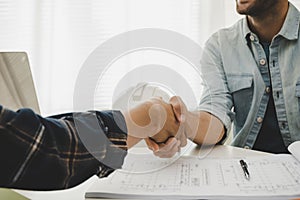 Construction worker team contractor handshake after finishing business meeting to start up project contract in construction site b