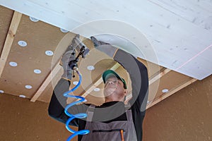 Construction worker thermally insulating eco wooden frame house