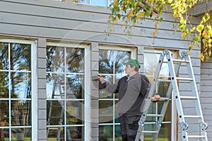 Construction worker thermally insulating eco wooden frame house