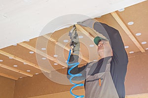 Construction worker thermally insulating eco wooden frame house