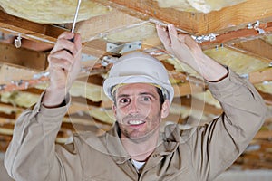 Construction worker thermally insulating eco wooden frame house