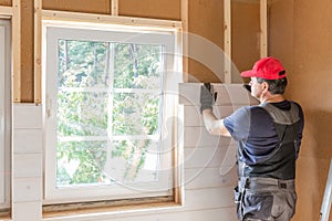 Construction worker thermally insulating eco wooden frame house