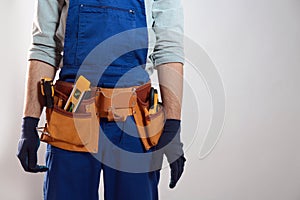 Construction worker with tool belt, closeup. Space for text