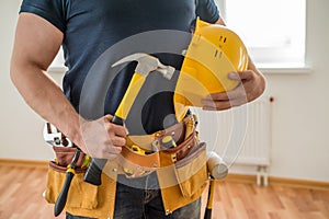 Construction worker with tool belt and hammer