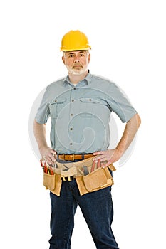 Construction Worker With Toolbelt And Hardhat Standing Tall photo