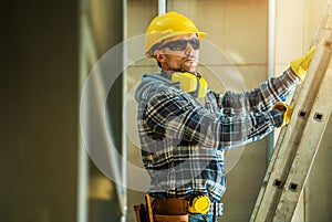 Construction Worker Unfolding a Ladder