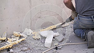 a construction worker uses a jackhammer