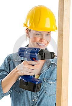 Construction Worker Using Cordless Drill On Wooden Plank